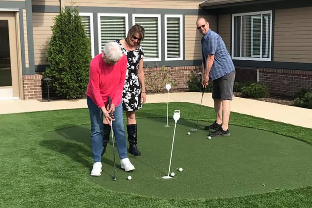 senior golfing on the putting green