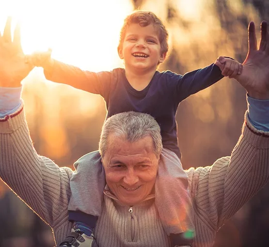 Man holding child on shoulders