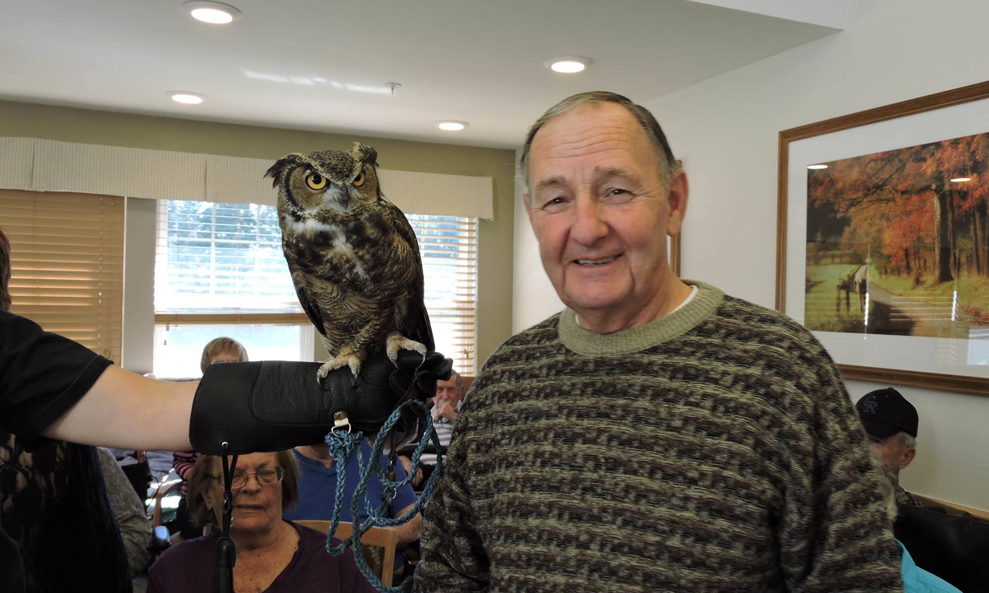 Man with an owl at senior living in IL