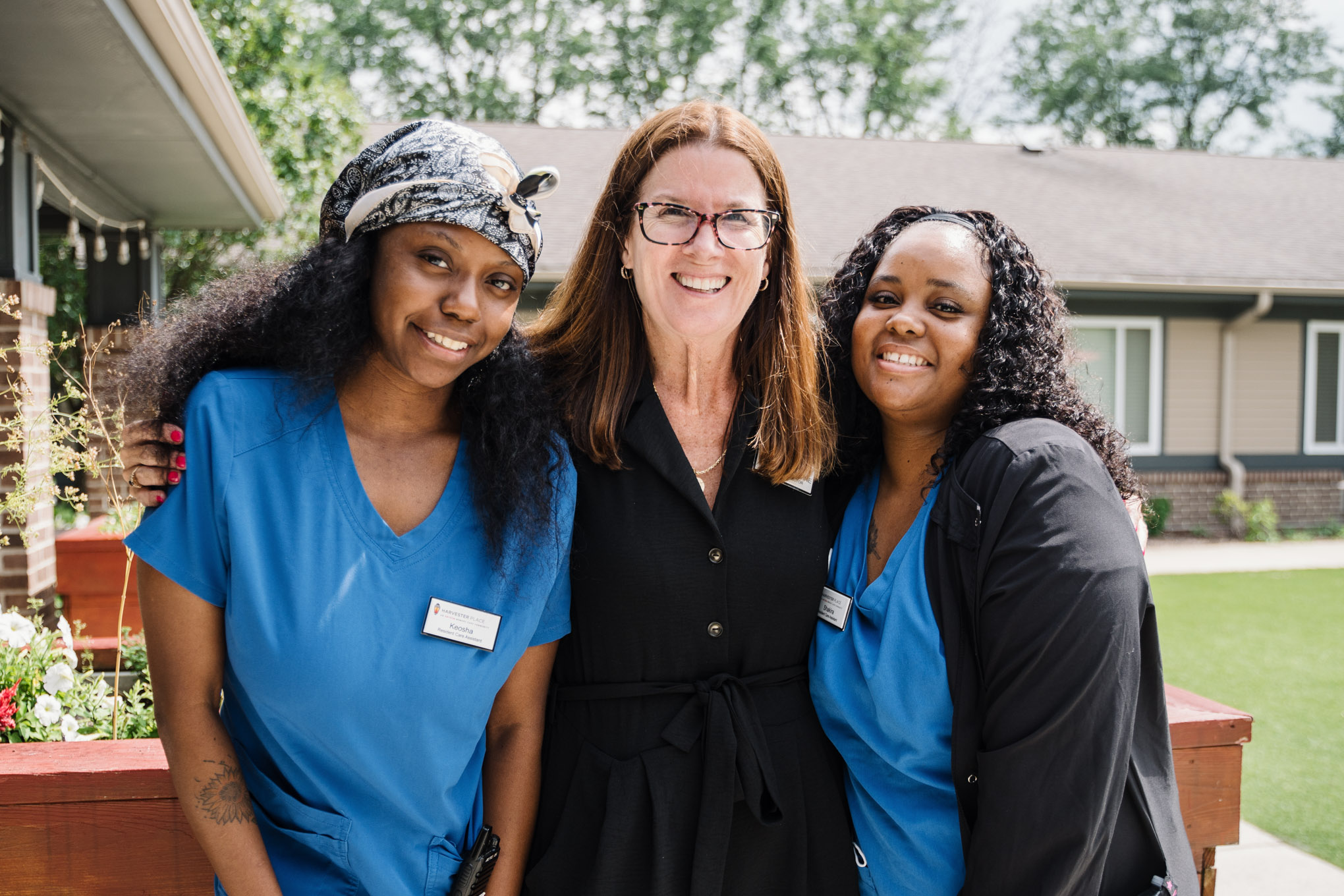 Harvester Place Executive Director and two staff members smiling