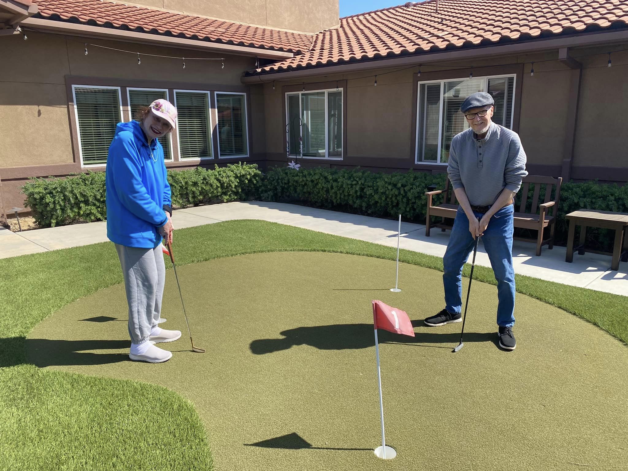 two residents putting at Vineyard Place